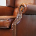 Comfortabele Schapenleren Oorfauteuil Met Een Afwerking Met Siernagels En Warme Kleuren thumbnail 12