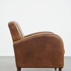 Cognac-Kleurige Rundleren Armchair Met Een Strak Design En Comfortabele Zit thumbnail 4